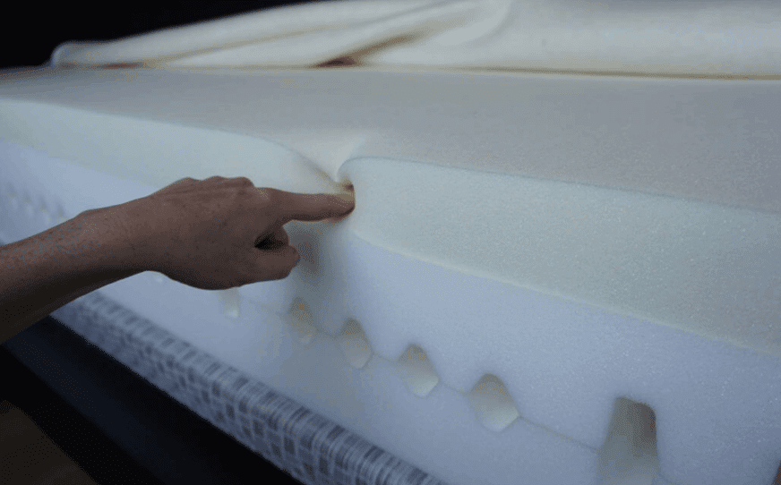 A person checking the memory foam softness